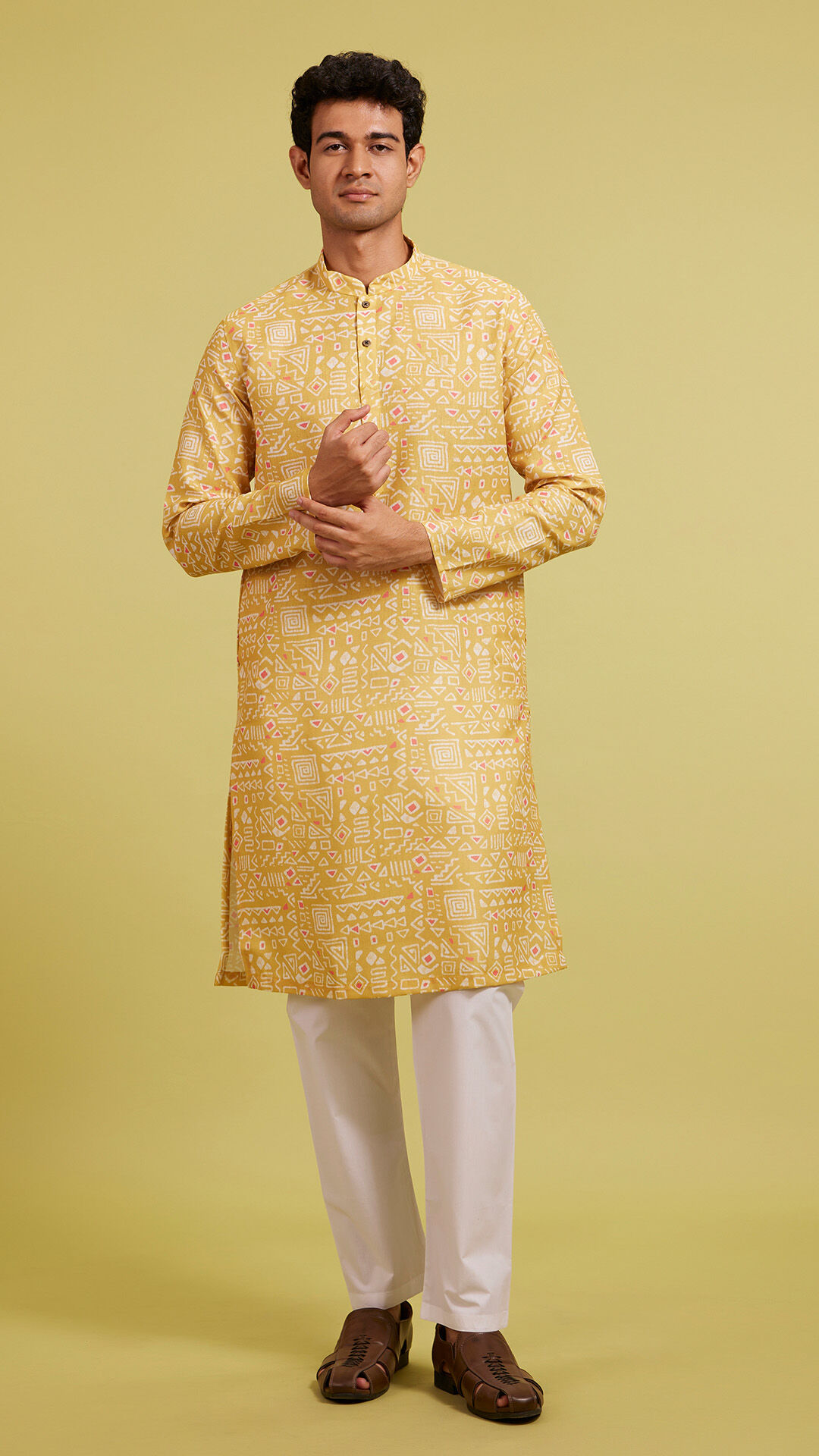 Men&rsquo;s golden yellow festive kurta paired with white trousers, showcasing an elegant ethnic wear look.